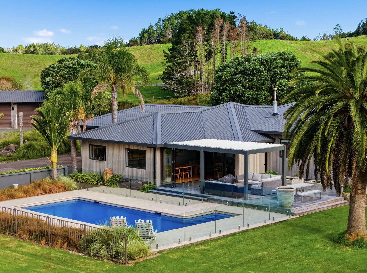 Architectural home with swimming pool and palms at 4 Hamilton Road, Warkworth